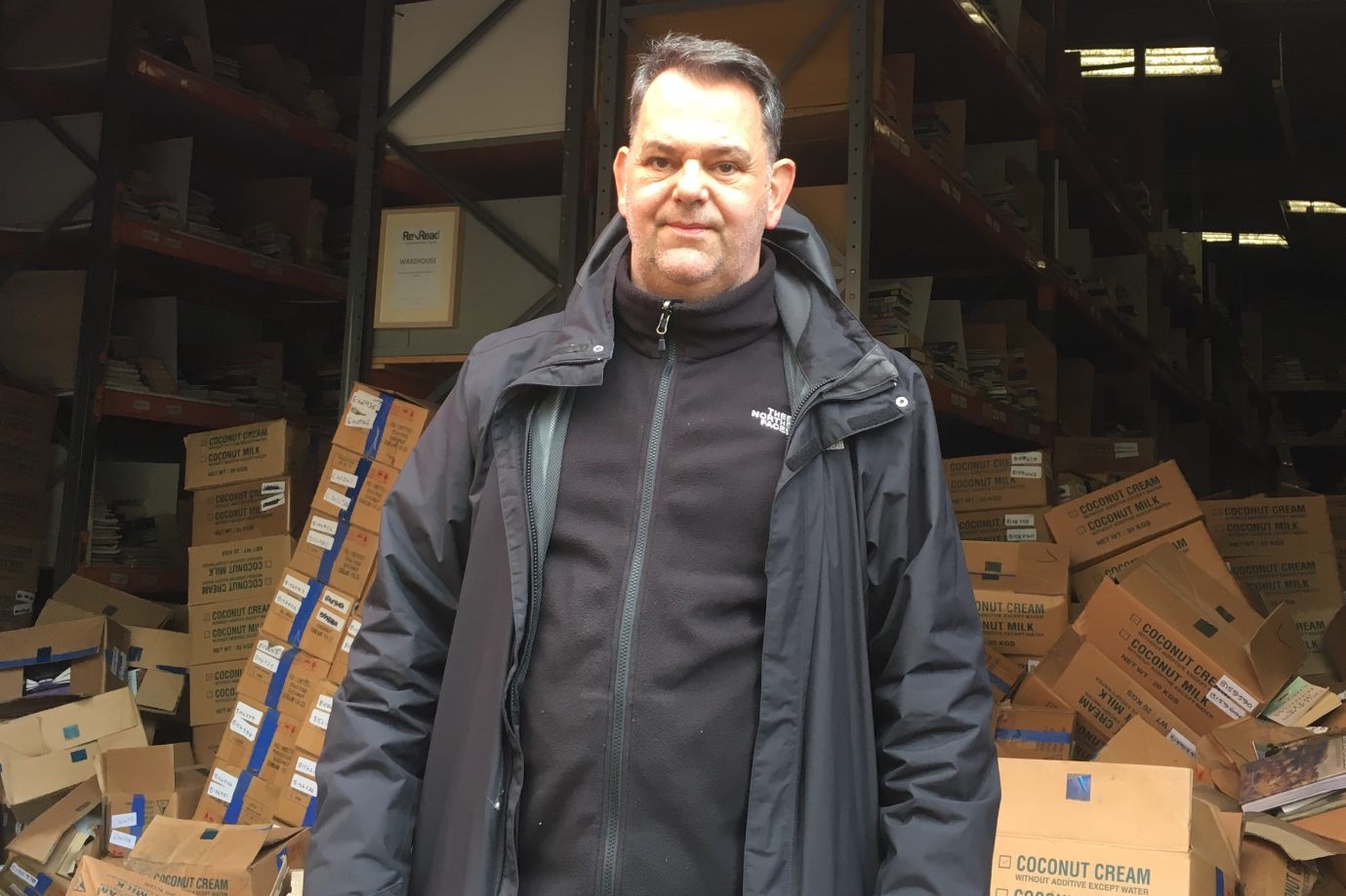 Jim McLaughlin standing in front of a warehouse